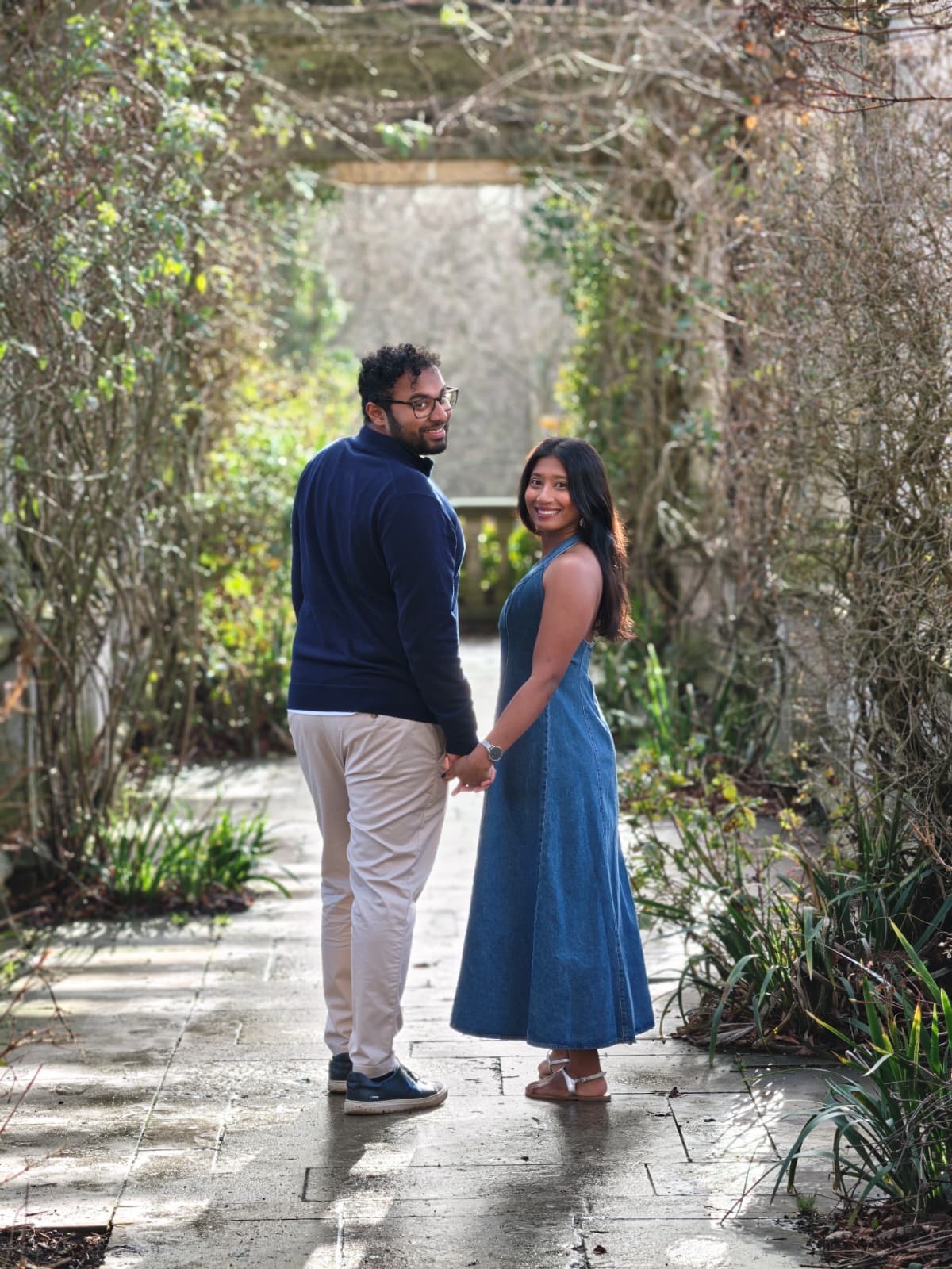 Charith and Harindi looking back along a garden path